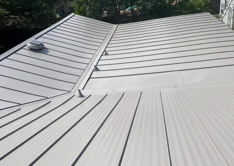 Solar attic fan installed on a metal roof for Roof Ventilation in Central